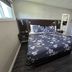 Hillside Inn Pembroke guest room with queen bed, floral bedding, and dark wood flooring in Pembroke