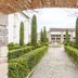Hôtel La Métairie in Cordes-sur-Ciel, framed garden walkway with manicured hedges and cypress trees