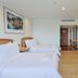 The Royal City Hotel in Bangkok guest room with two twin beds and wall-mounted TV