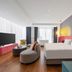 Yiting Huicheng Hotel Xiamen room with bed, sofa, TV and large floor-to-ceiling windows