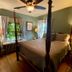 Williamsburg Manor B&B bedroom in Williamsburg with four-poster bed, ceiling fan, and window seating