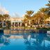 JW Marriott St. Maarten Beach Resort & Spa pool with palm trees and oceanfront resort buildings in Upper Prince's Quarter