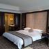 Shangmao International Hotel Nanjing guest room with king bed, tufted headboard and patterned carpet