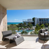 TRS Coral Hotel in Cancún balcony with lounge chairs, pool, and ocean view