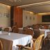 Hotel Goldinger, Landstuhl: elegant hotel dining room with set tables, chairs, and chandeliers