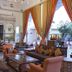 Samode Haveli Jaipur lounge with ornate carved arch, colorful drapes and courtyard seating
