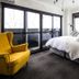 Hotel Villa Hakuba By Hhg room in Hakuba with bed, yellow armchair, and large sliding glass doors