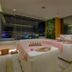 Tms Hotel Da Nang Beach spa treatment room with massage tables and city view in Da Nang