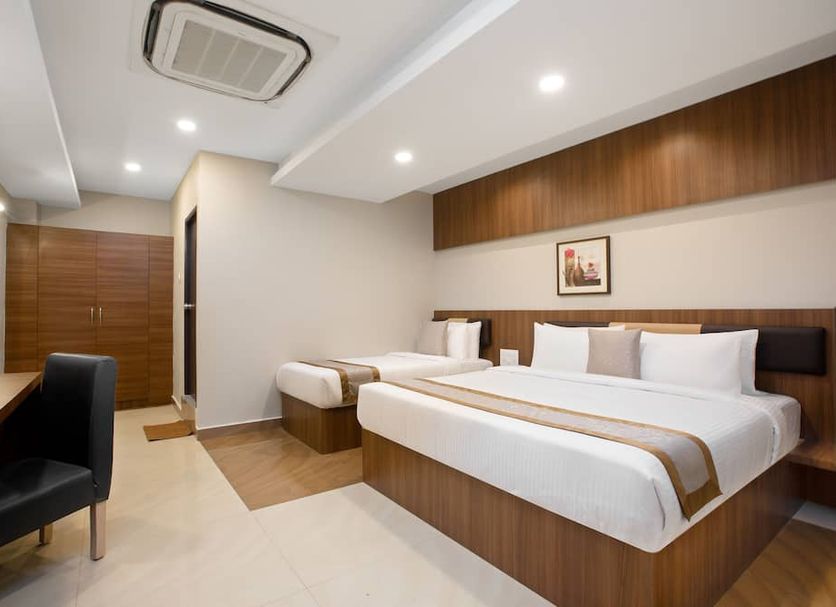 Grande Inn Tiruchirappalli guest room with double bed, desk, chair, and air conditioning