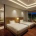 The Ubufuru Ishigaki guest room with twin beds and a private balcony view in Ishigaki