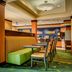Fairfield Inn & Suites by Marriott Indianapolis Noblesville lobby seating area with booth and tables