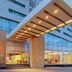 Hotel Opus Grand Toluca Aeropuerto entrance with canopy and lit lobby in Toluca