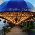 Doolan's Shore Club in Spring Lake Heights with a blue canopy entrance and hanging lights at dusk
