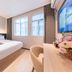 7 Days Inn Guangzhou Beijing Road Metro Branch room with bed, desk, chair and two windows in Guangzhou