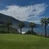 Monte Mar Palace Hotel in São Vicente with oceanfront lawn, palm trees and mountain sea views