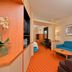Fairfield Inn and Suites by Marriott Williamsport guest room with sofa, desk, and TV