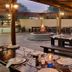Anew Resort White River Mbombela outdoor dining area with fire pit and wooden tables at dusk