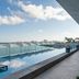 Canopy by Hilton Cancun La Isla rooftop infinity pool overlooking Cancun skyline and Ferris wheel