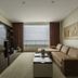Enjoy Coquimbo hotel suite with sofa, TV wall, and ocean-view balcony in Coquimbo