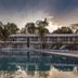 Le Pearl Goa Resort & Spa in Vagator with outdoor pool and sun loungers at sunset