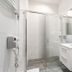 Royal Gdansk bathroom with glass shower enclosure, white vanity, and wall-mounted hair dryer in Gdansk