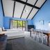 Oakwood Manor Motor Lodge in Mangere, blue room with bed, dining table, chairs and large window