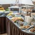 Breakfast buffet at Unahotels Eco Hotel Villa Costanza Venezia in Venice with pastries, fruit and coffee cups
