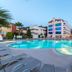 Ideal Pearl Hotel Adults Only in Marmaris with outdoor pool, loungers, and palm trees