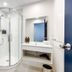 Mercure Wellington Abel Tasman bathroom with glass shower, vanity sink and toilet in Wellington