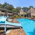 Sanctuary Resort Motor Inn in Coffs Harbour with outdoor pool and waterslide beside tropical resort buildings