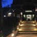 Night exterior of Villa Ambrosina in Impruneta, with lit steps leading to the hotel entrance