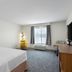 Hampton Inn & Suites Chicago Deer Park guest room with king bed, desk, window and TV