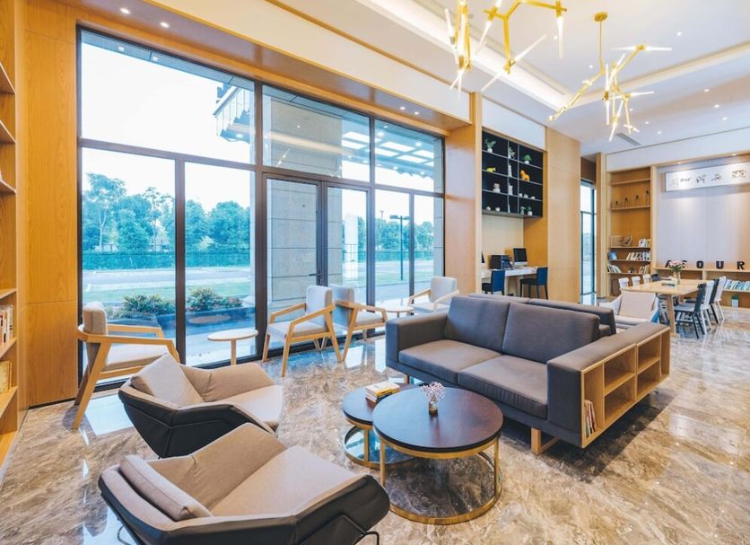 Binhai Jianguo Hotel in Tianjin lobby lounge with floor-to-ceiling windows and seating area