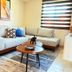 Hotel Del Pescador in Ajijic: bright lounge with sectional sofa, coffee table, rug and window blinds