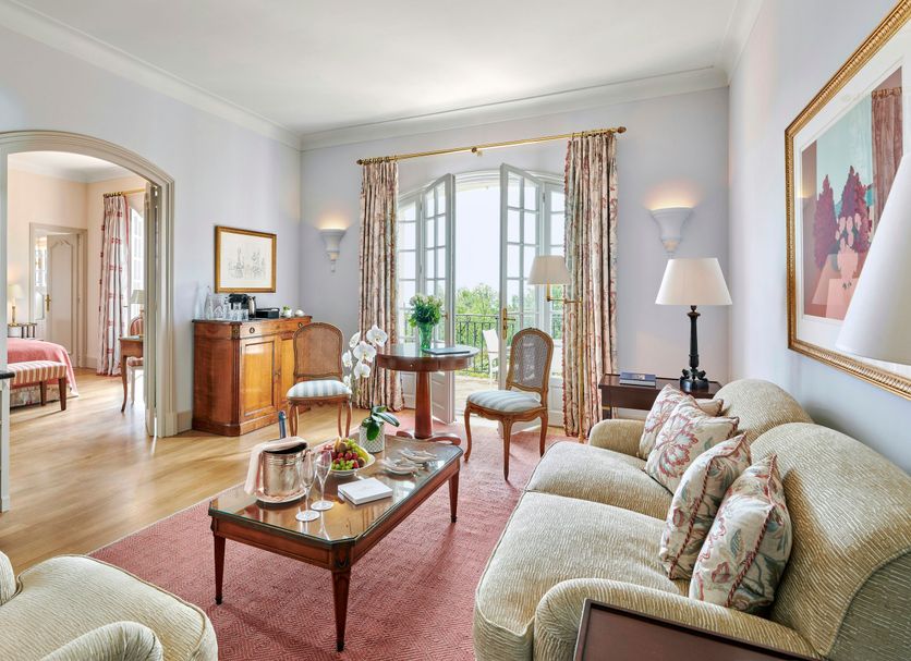 Chateau Saint Martin And Spa in Vence sitting room with sofa, chairs, coffee table and garden view