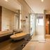 Fazenda Verde Praia do Rosa bathroom in Imbituba with vessel sink, glass shower, and wood closet doors