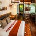 Rodavento Valle de Bravo loft suite with vaulted wood ceiling, bed, ladder, and warm ambient lighting