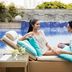 Couple relaxing on a poolside daybed at Fairfield by Marriott Bengaluru Outer Ring Road, Bengaluru