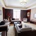 Fugang International Hotel in Meizhou living room suite with sofa, armchairs, TV, and large window