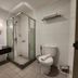 Bathroom at Hotel Glodok Plaza in Jakarta with glass shower, sink, toilet and mirror