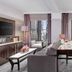 Westhouse Hotel New York suite with city view, sofa seating and dining table in New York