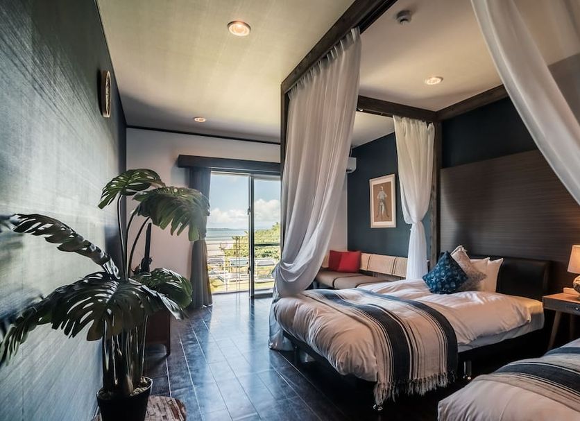 The Beach Terrace Hotel Ao Ishigaki room with canopy beds and sliding doors to balcony, Ishigaki