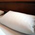 Salzufler Hof, Bad Salzuflen: close-up of a bed with white pillows and warm bedside lamp