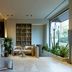 UNA Hotels Villa Dei Platani Foligno lobby lounge with seating, plants, shelving and large windows
