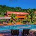 Frangipani Hotel Boutique in Brotas with curved pool, loungers and tropical hillside setting