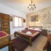 Spot Hotel Rhodes guest room with three beds, stone accent wall, chandelier and window