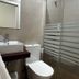 Bathroom at Hostal Mellizo in Lebrija with sink, toilet, and glass-enclosed shower