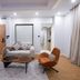 Arabella Residence Cairo living room with sofa, lounge chairs and coffee table in a bright modern suite