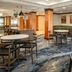 Fairfield Inn & Suites by Marriott Santa Maria lounge with tables, chairs and green banquette seating