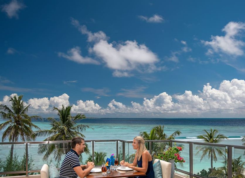 Seasalter Maldives in Malé terrace dining with ocean view, palm trees and turquoise water